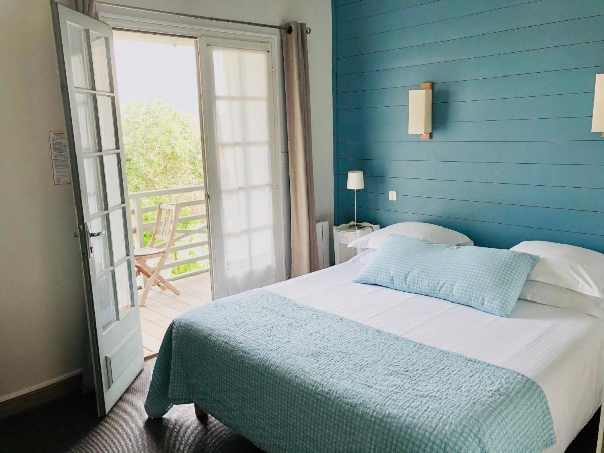 Un ou plusieurs lits dans un hébergement de l'établissement Hotel L'Océan