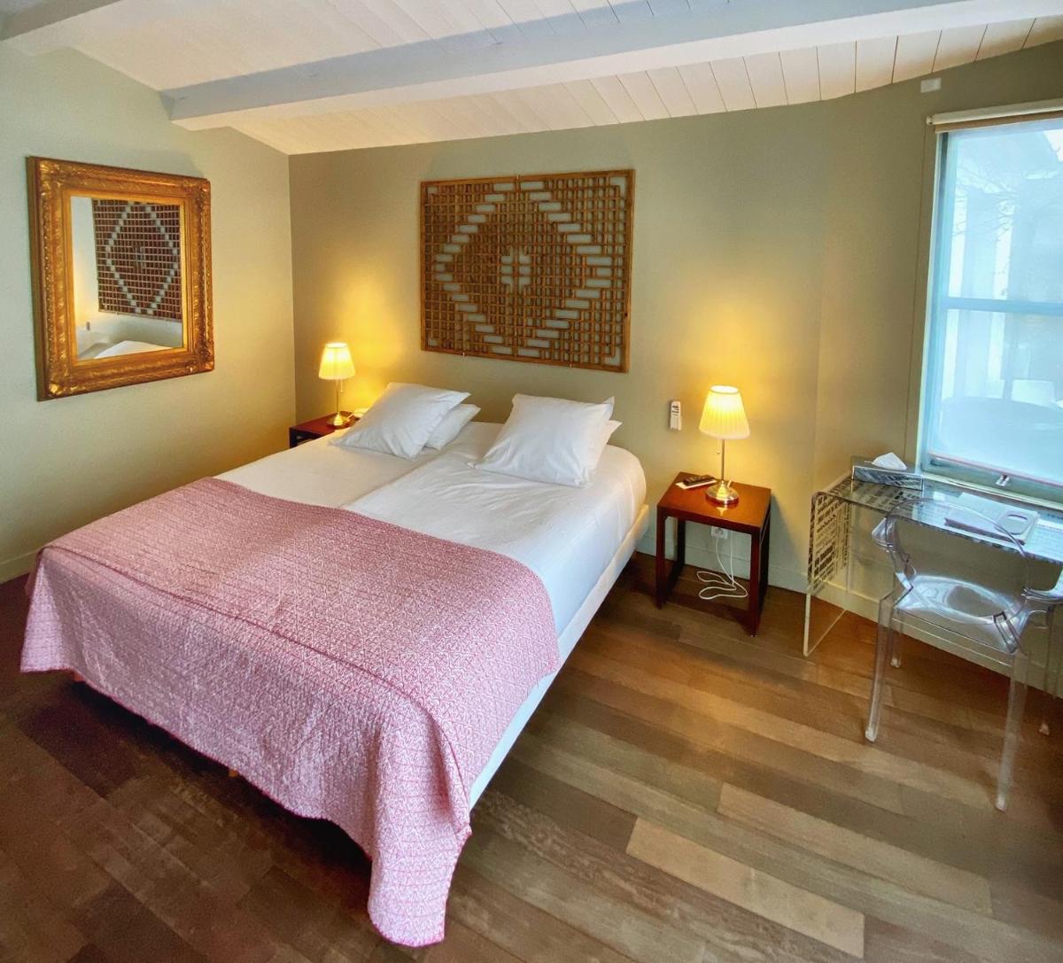 Un ou plusieurs lits dans un hébergement de l'établissement Hotel L'Océan