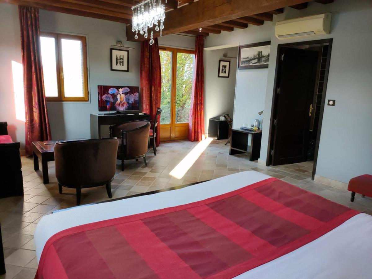 Un ou plusieurs lits dans un hébergement de l'établissement Demeures & Châteaux Hôtel Domaine le Clos des Fontaines