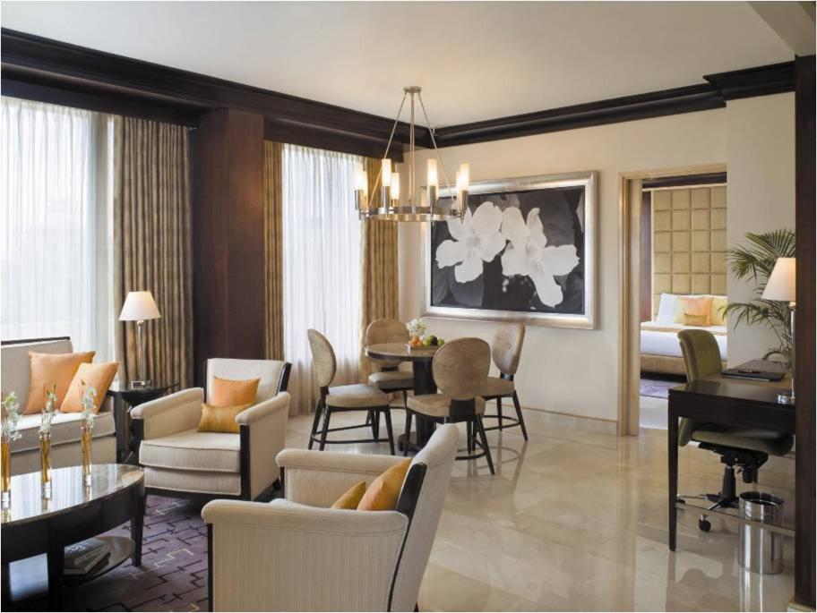 a living room with a piano and a dining room at Blue Diamond Pune IHCL SeleQtions in Pune
