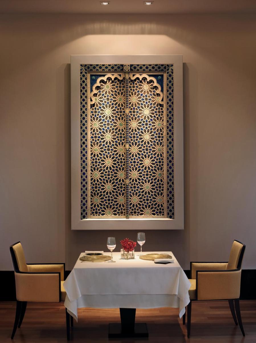 a dining room with a table and a window at The Oberoi Mumbai in Mumbai
