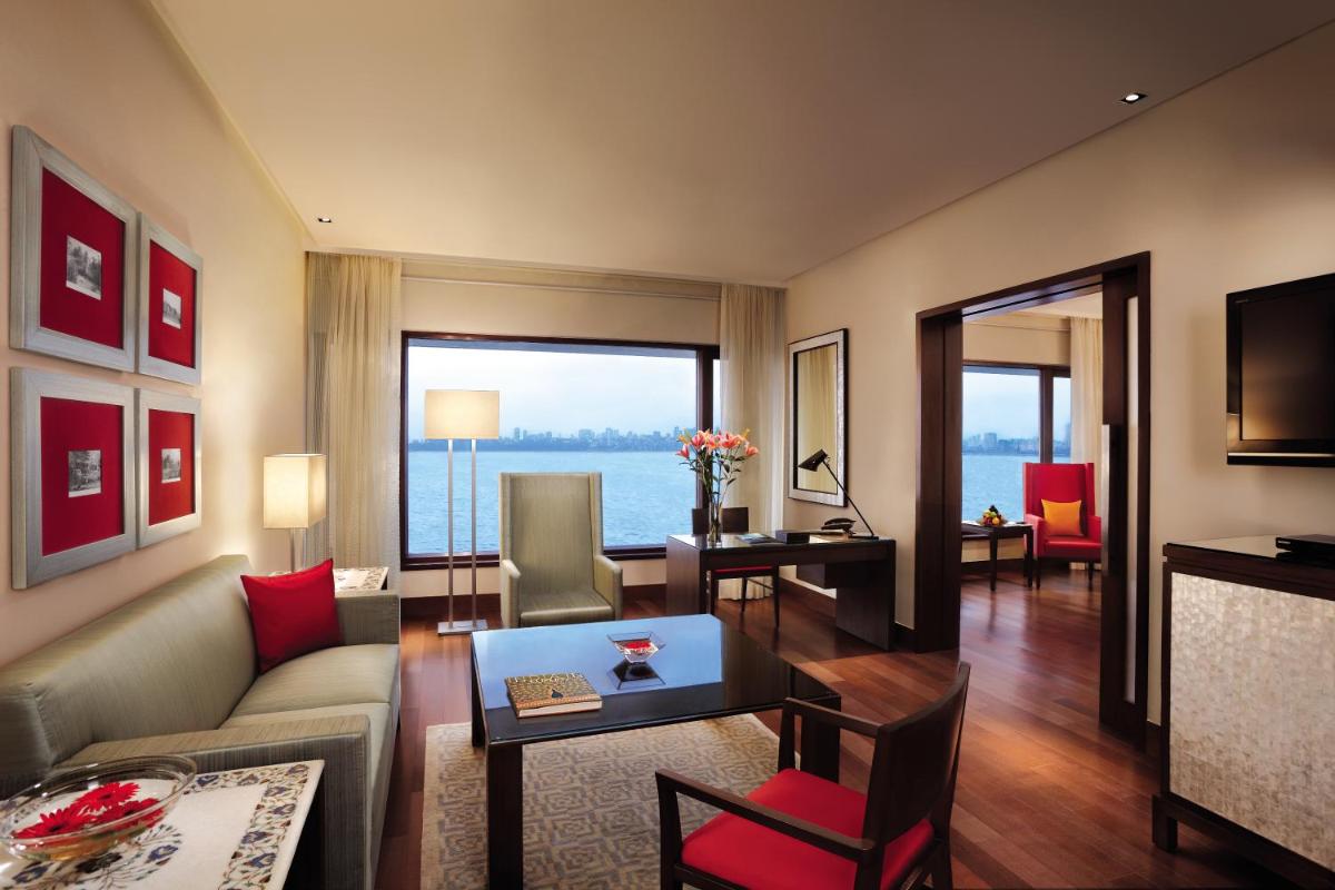 a living room with a couch and a table at The Oberoi Mumbai in Mumbai