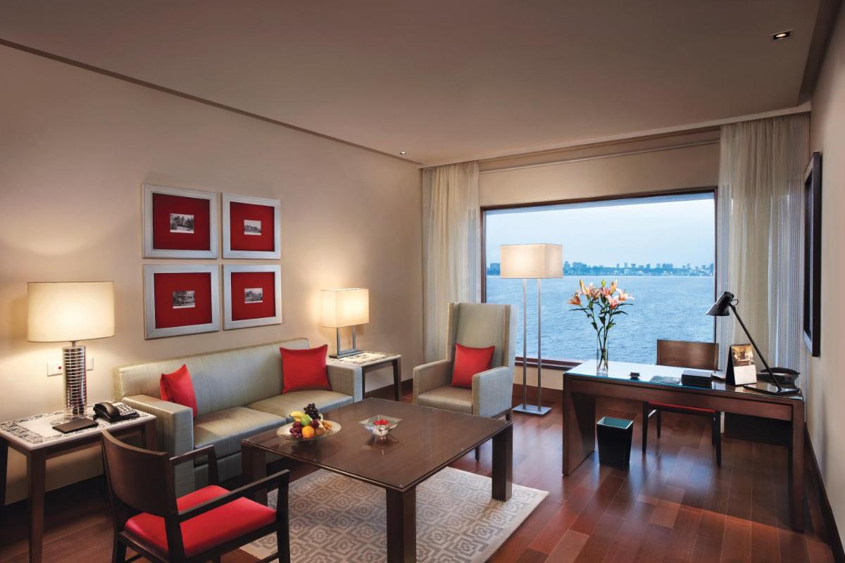 a living room with a couch and a table at The Oberoi Mumbai in Mumbai