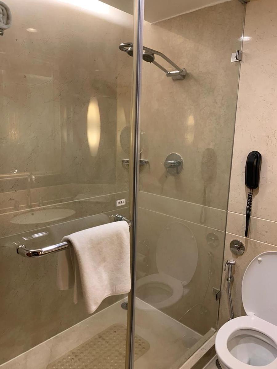 a bathroom with a glass shower with a toilet at Blue Diamond Pune IHCL SeleQtions in Pune