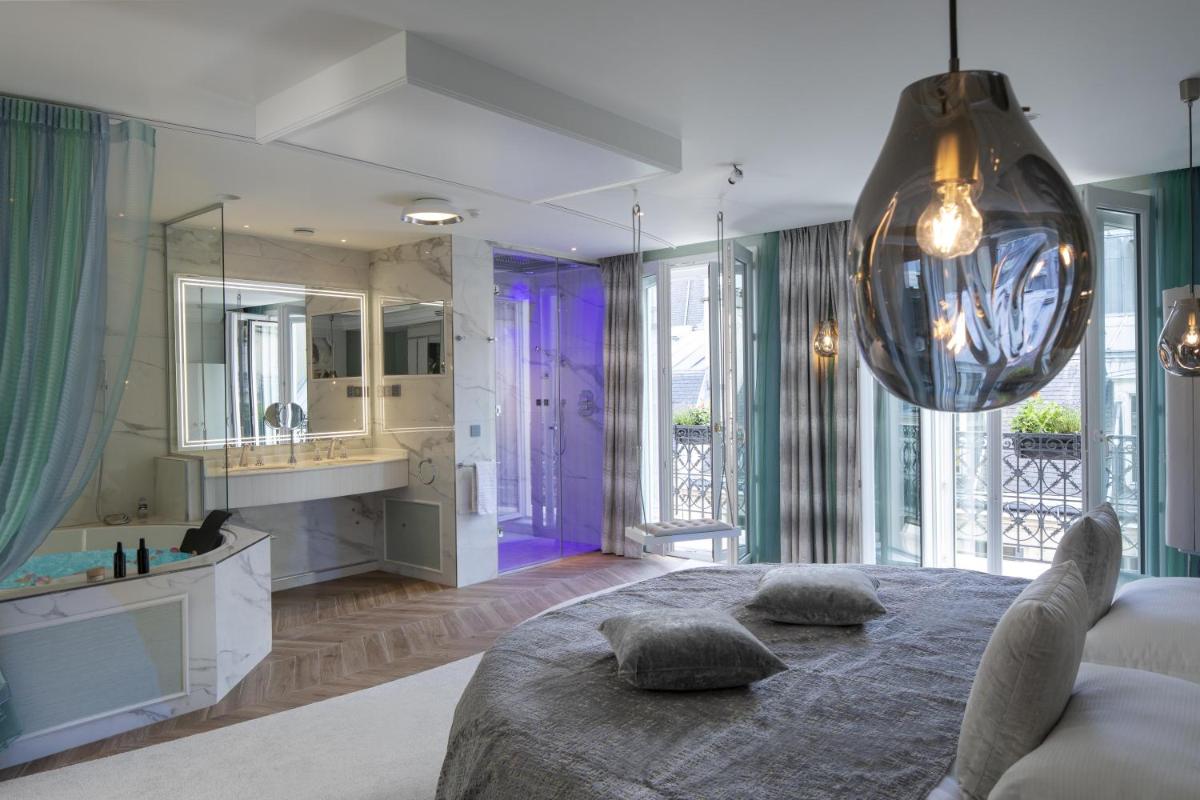 Un ou plusieurs lits dans un hébergement de l'établissement Paris j'Adore Hotel & Spa