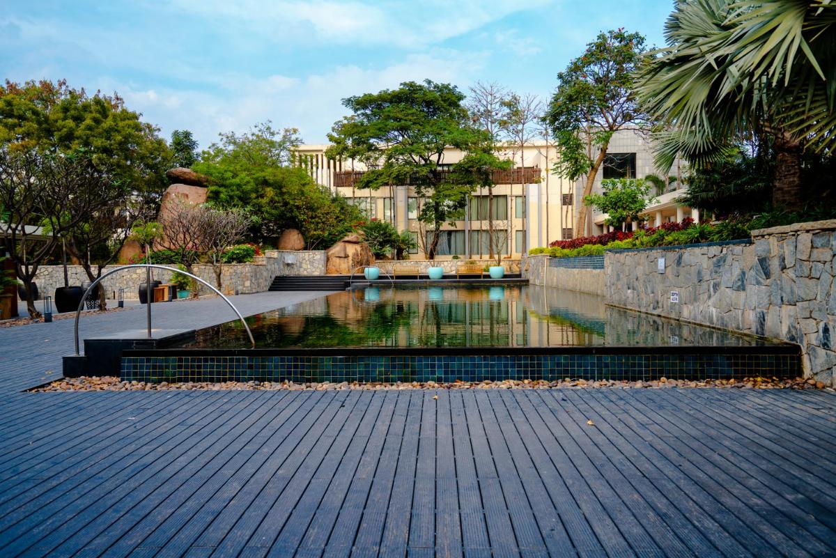 a pool of water in front of a building at Hyatt Hyderabad Gachibowli in Hyderabad