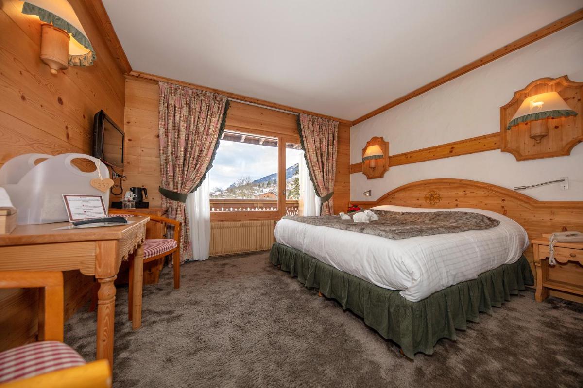Un ou plusieurs lits dans un hébergement de l'établissement Chalet-Hôtel Neige et Roc, The Originals Relais