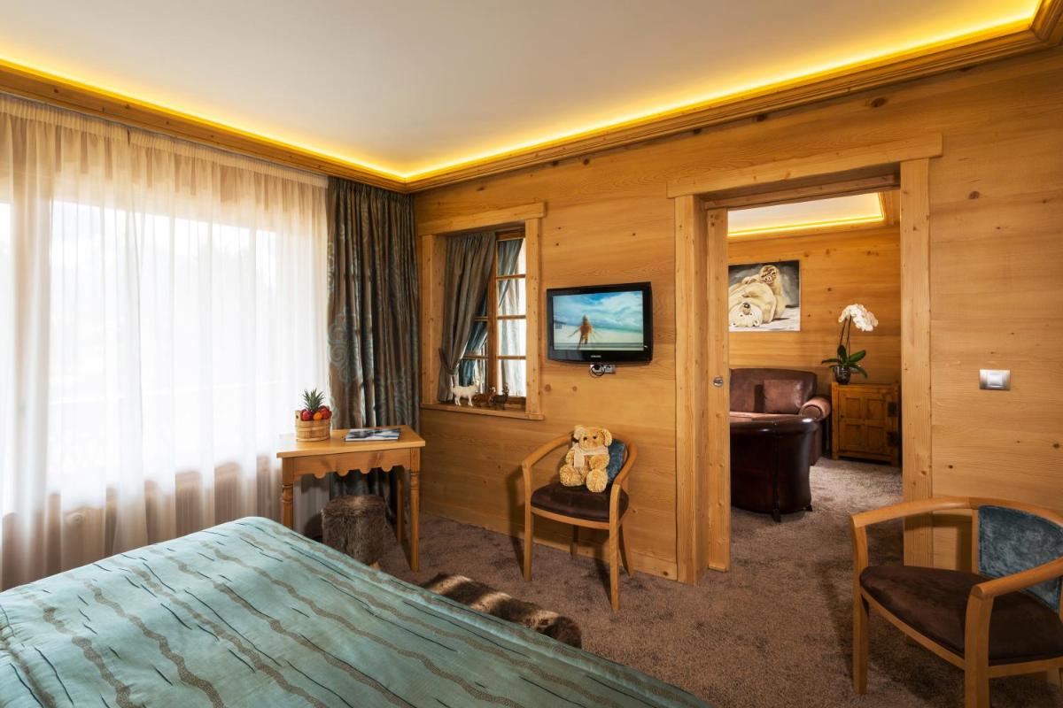 Un ou plusieurs lits dans un hébergement de l'établissement Chalet-Hôtel Neige et Roc, The Originals Relais