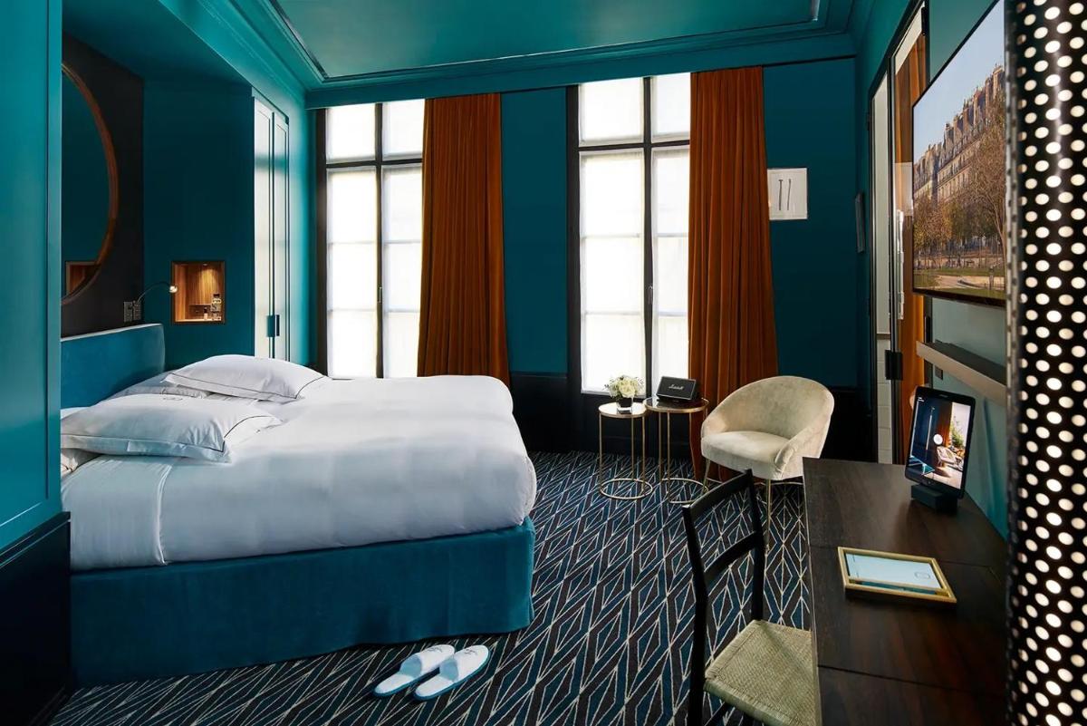 Un ou plusieurs lits dans un hébergement de l'établissement Le Roch Hotel & Spa