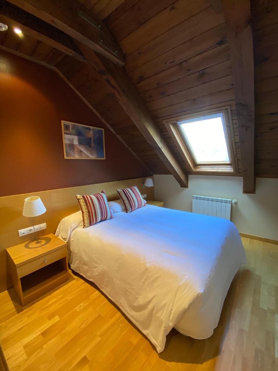 Cama o camas de una habitación en Aparthotel Siente Boí & SPA