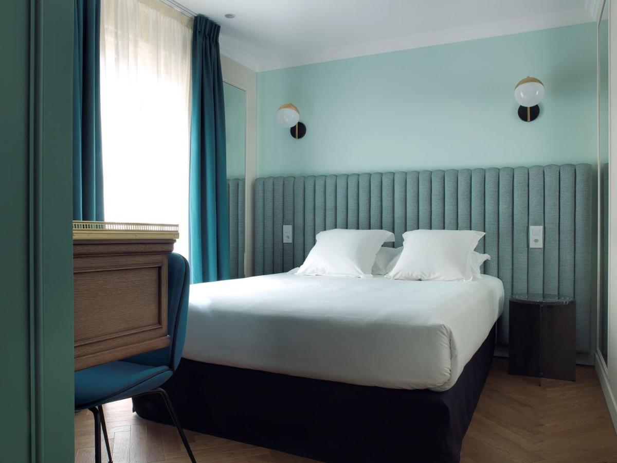 Un ou plusieurs lits dans un hébergement de l'établissement Hotel Bachaumont