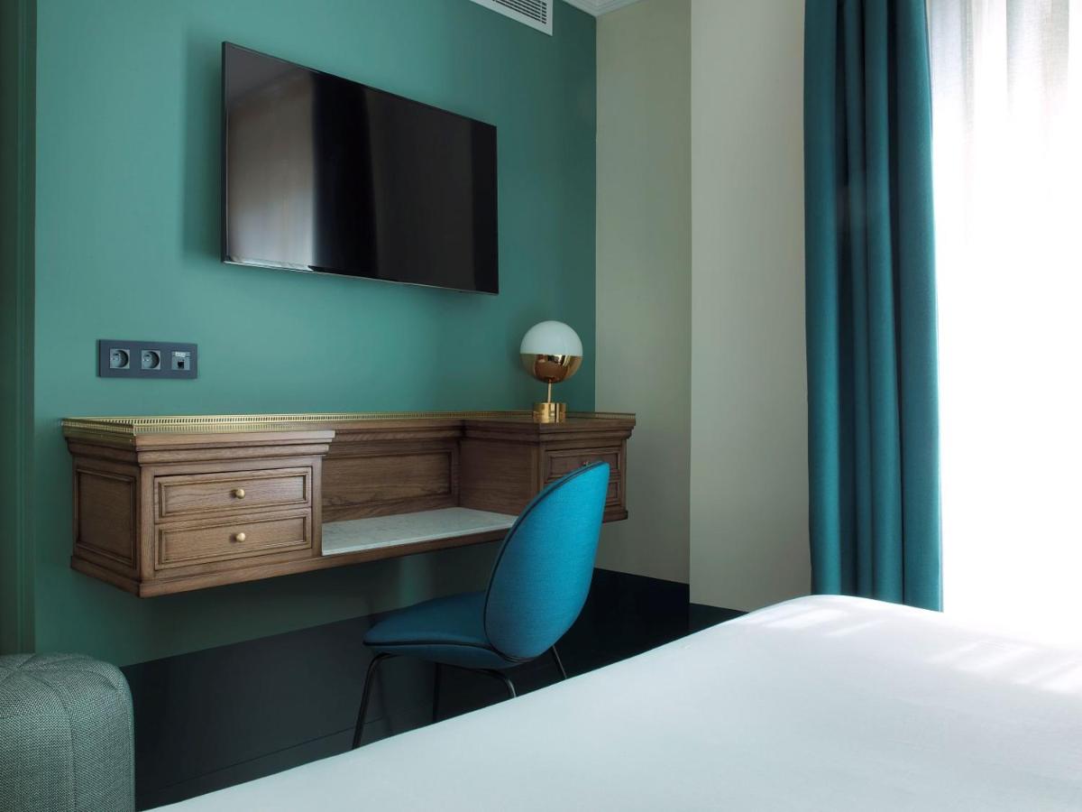 Un ou plusieurs lits dans un hébergement de l'établissement Hotel Bachaumont