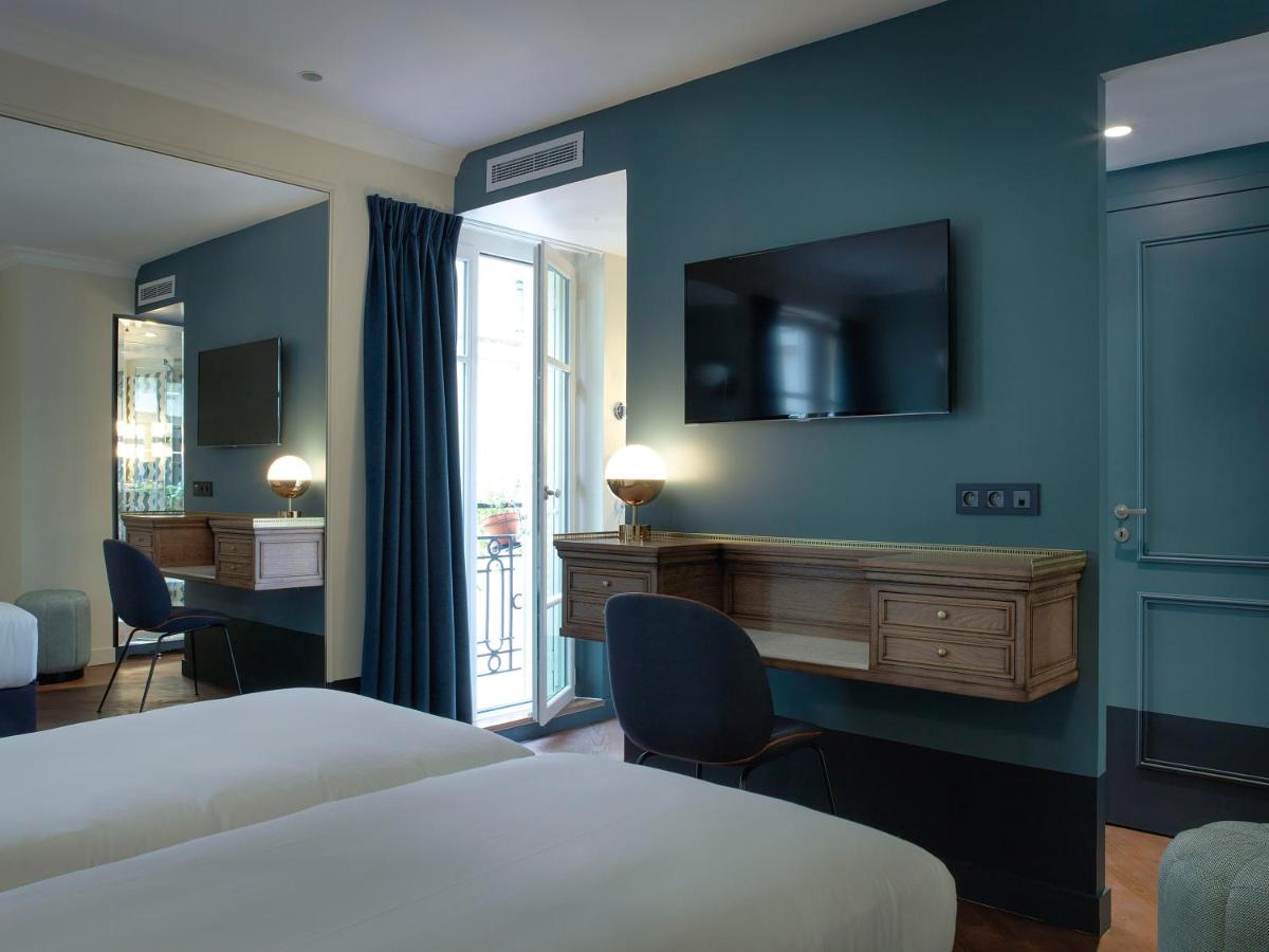 Un ou plusieurs lits dans un hébergement de l'établissement Hotel Bachaumont