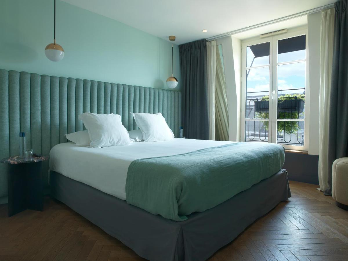 Un ou plusieurs lits dans un hébergement de l'établissement Hotel Bachaumont