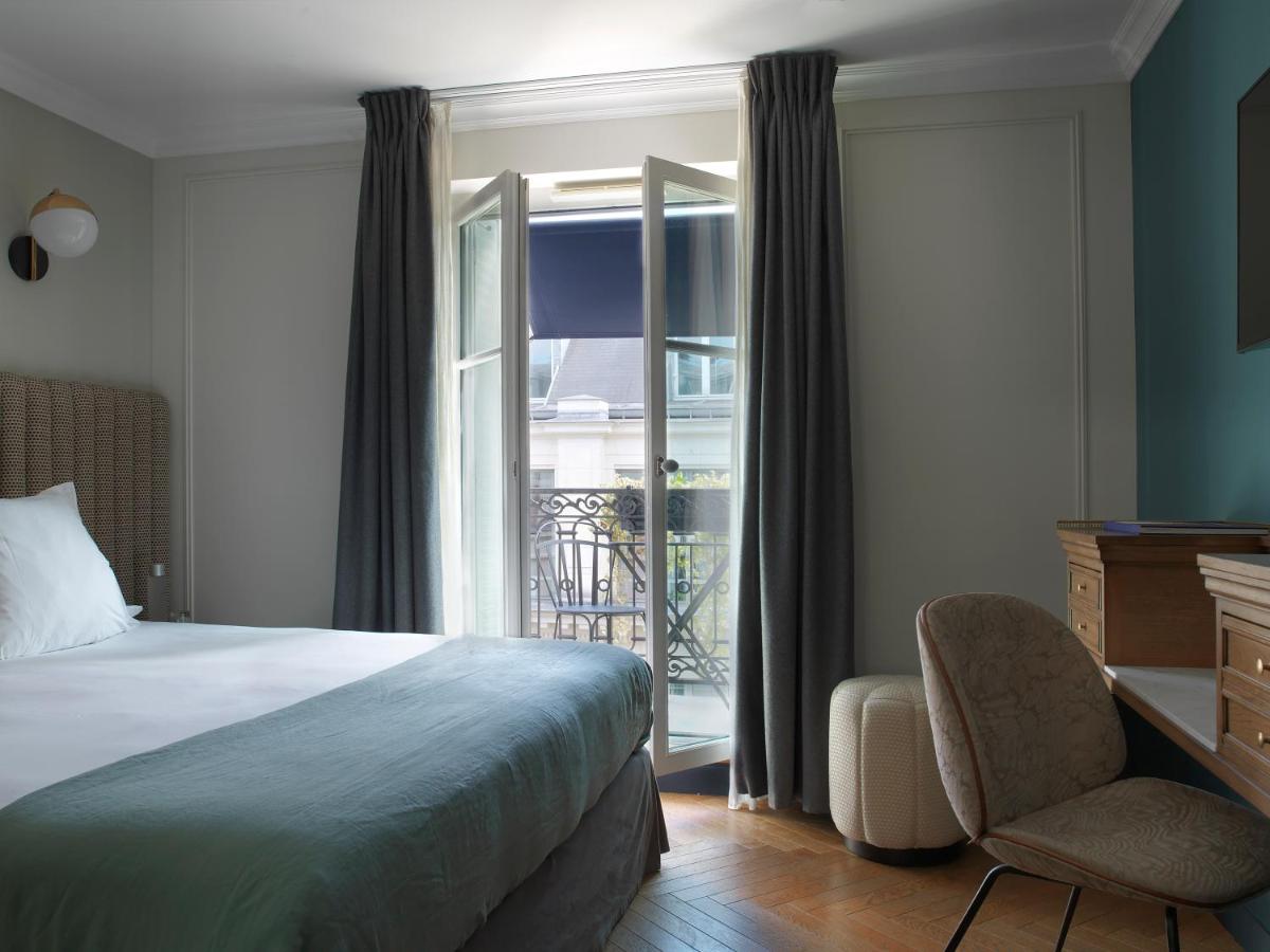 Un ou plusieurs lits dans un hébergement de l'établissement Hotel Bachaumont