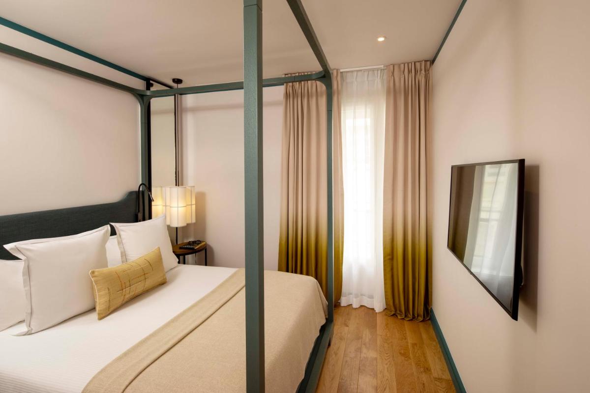 Un ou plusieurs lits dans un hébergement de l'établissement Hôtel Bel Ami