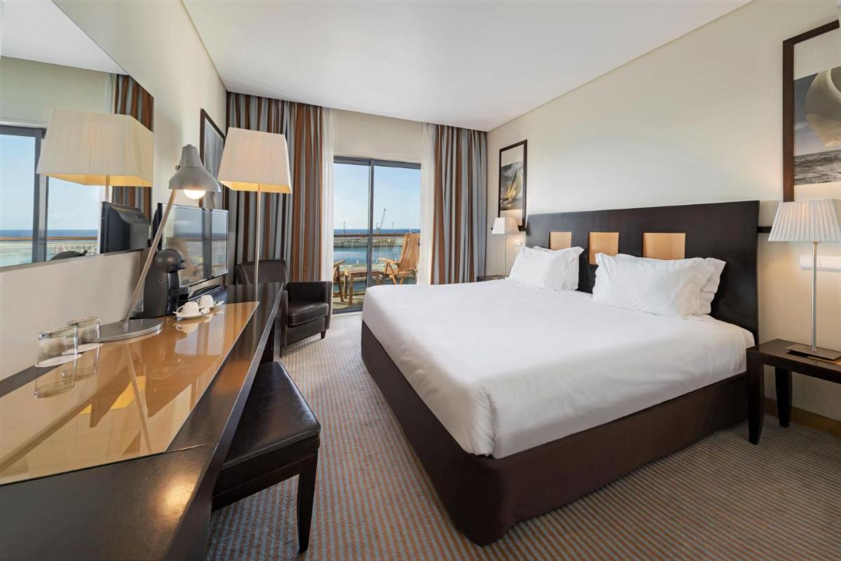 Uma cama ou camas num quarto em Hotel Marina Atlântico