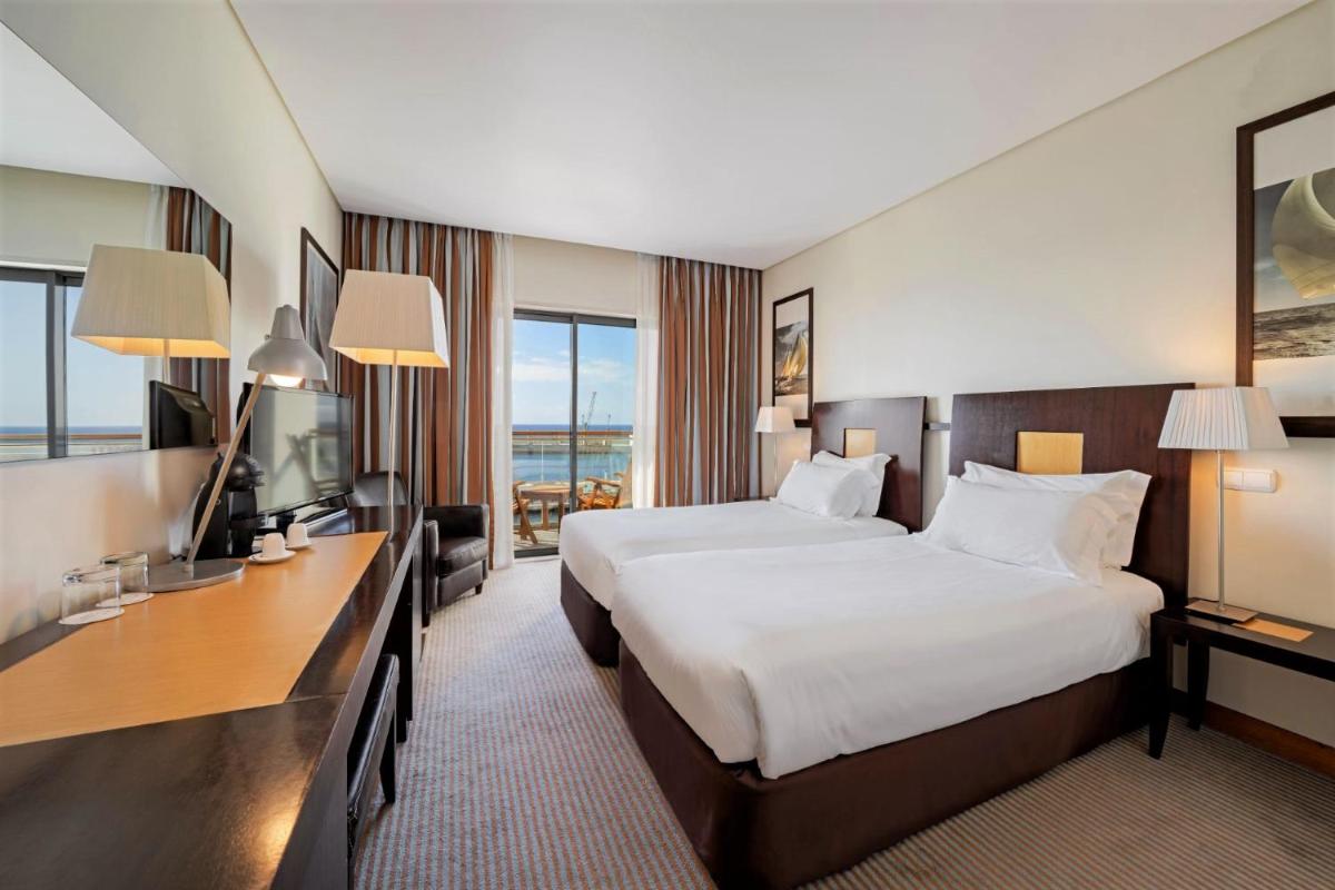 Uma cama ou camas num quarto em Hotel Marina Atlântico