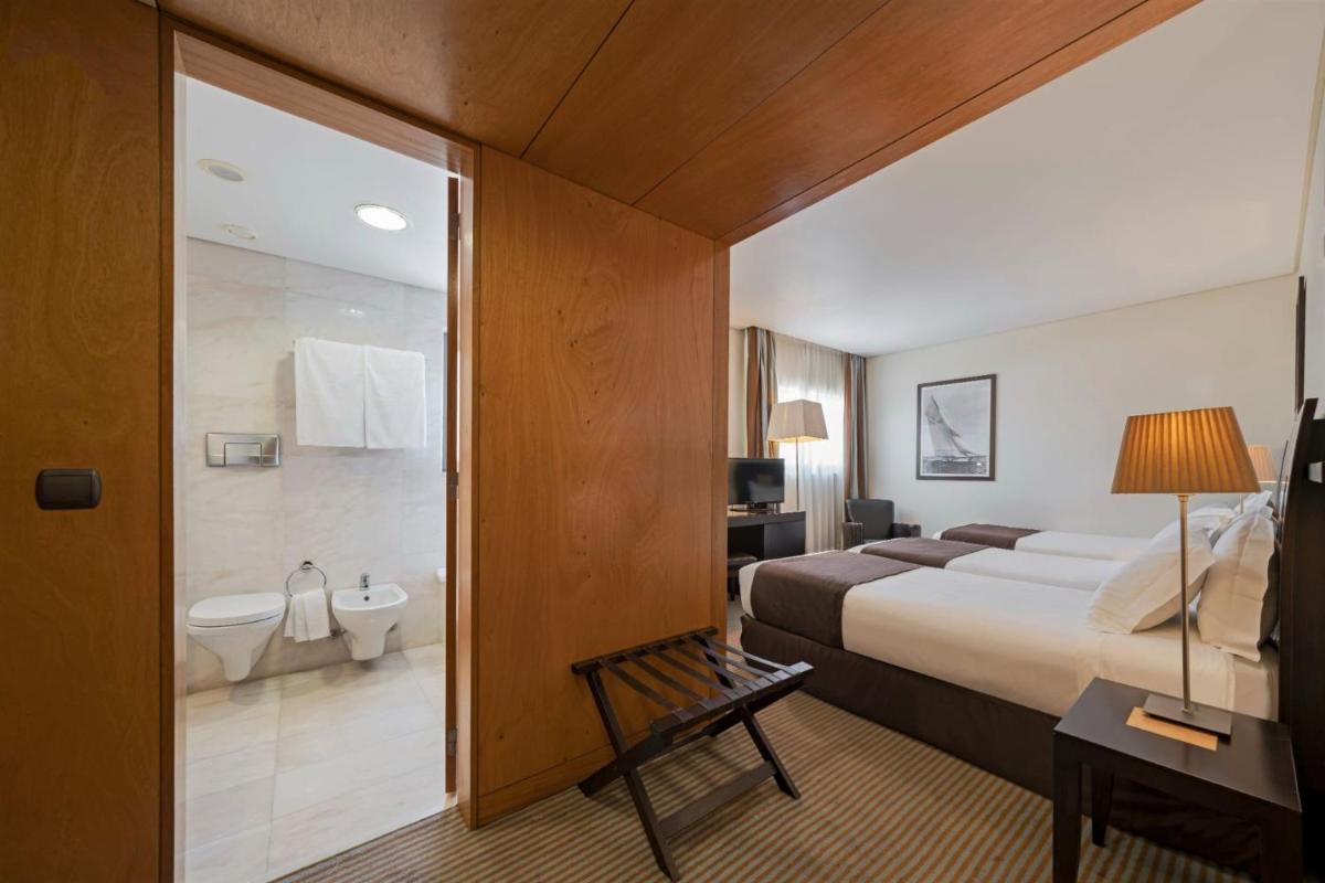 Uma cama ou camas num quarto em Hotel Marina Atlântico