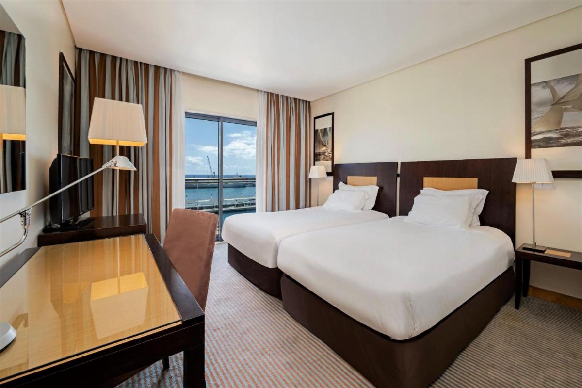 Uma cama ou camas num quarto em Hotel Marina Atlântico