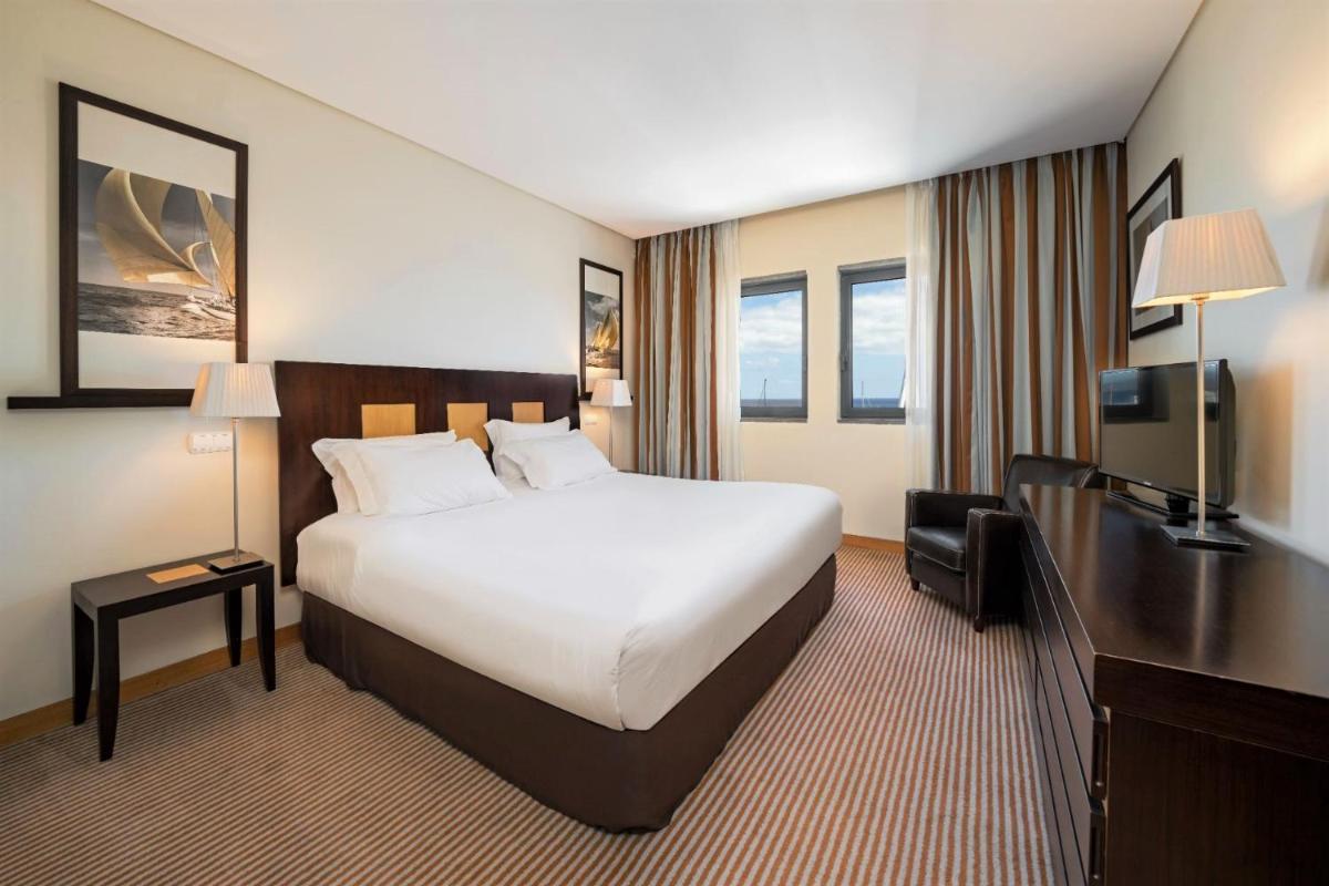 Uma cama ou camas num quarto em Hotel Marina Atlântico