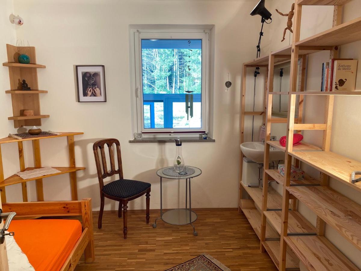ein Zimmer mit einem Schreibtisch und einem Stuhl und einem Fenster in der Unterkunft Haus am Waldpark in Scheidegg