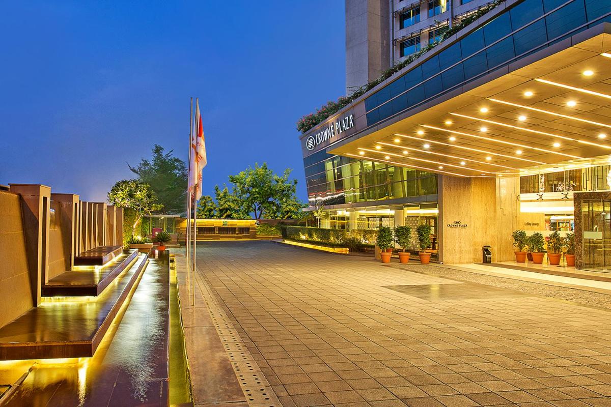 a large building with a flag in front of it at Crowne Plaza Ahmedabad City Centre by IHG in Ahmedabad