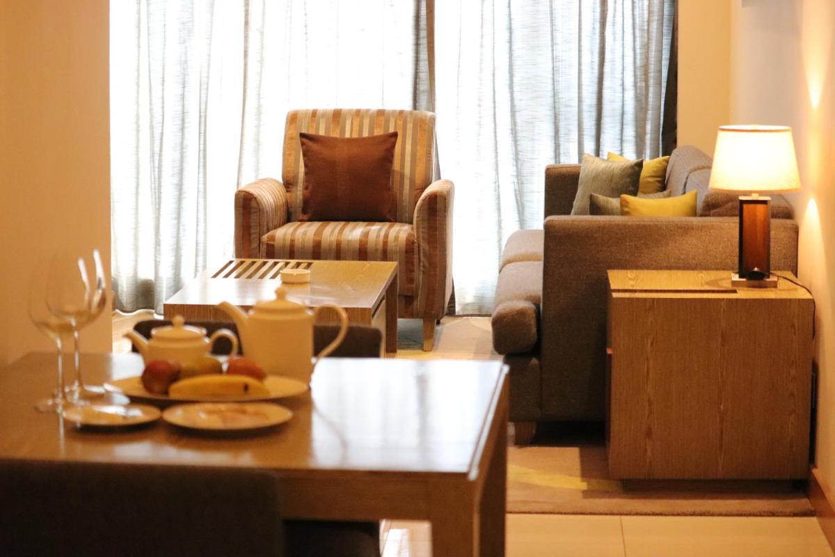 a living room with a couch and a table at Oakwood Residence Kapil Hyderabad in Hyderabad
