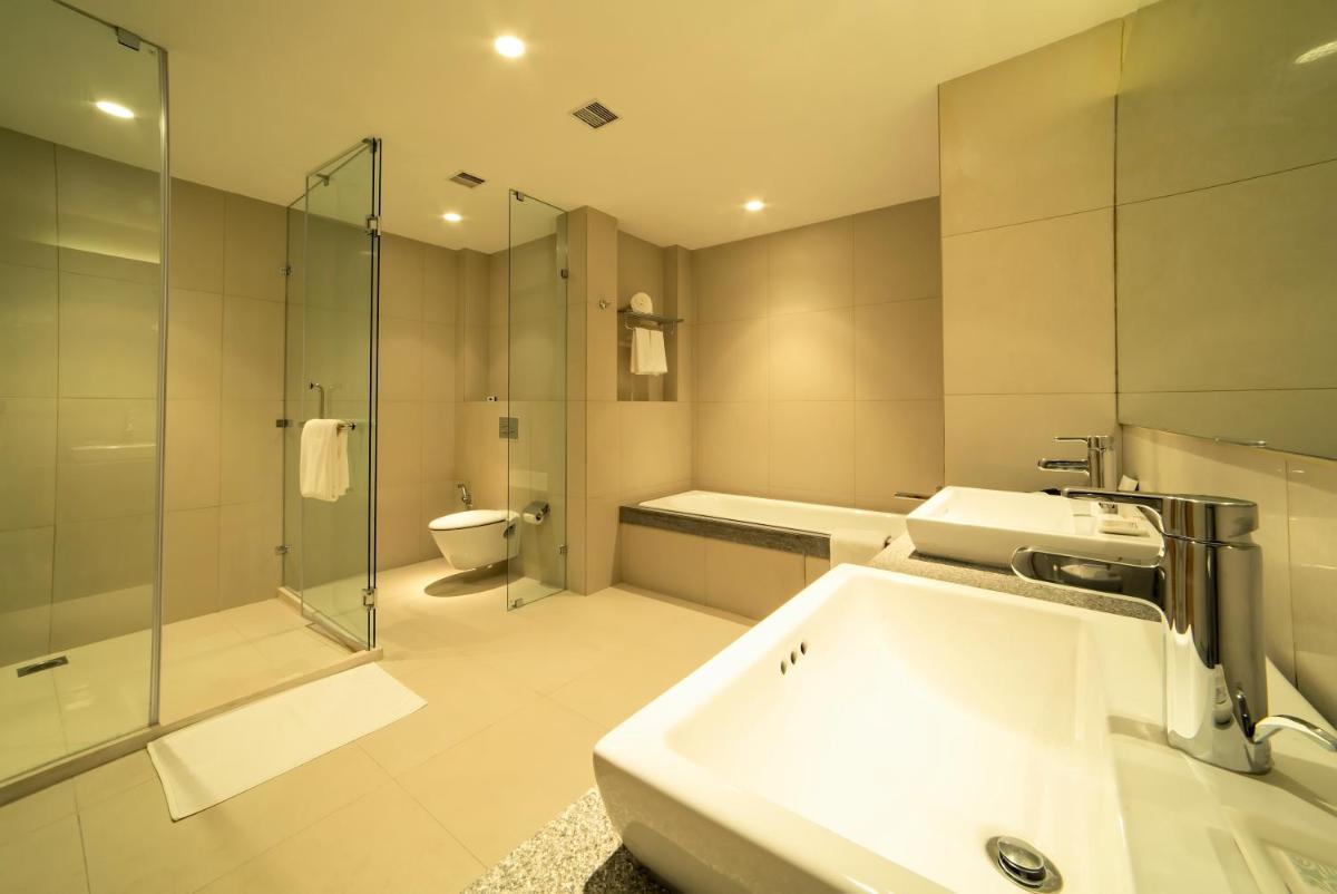 a bathroom with a sink and a shower and a toilet at Oakwood Residence Kapil Hyderabad in Hyderabad