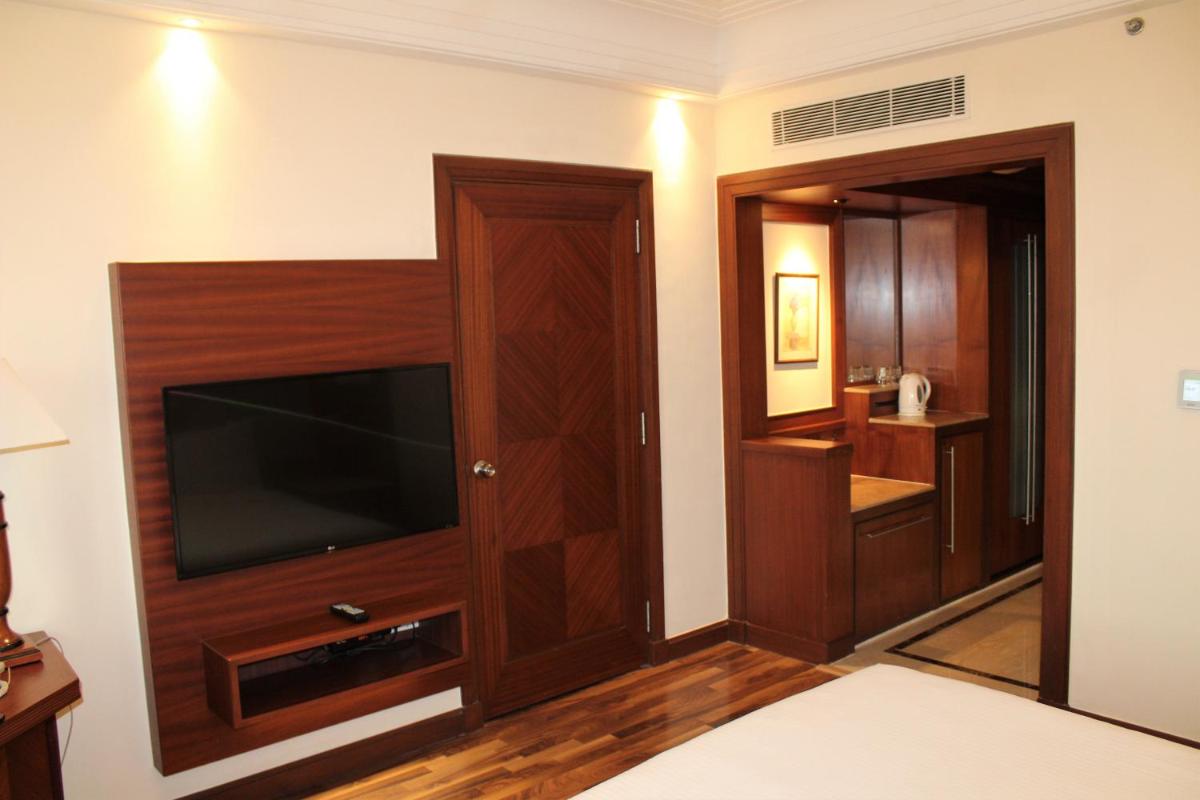 a living room with a flat screen tv in a room at The Accord Metropolitan in Chennai
