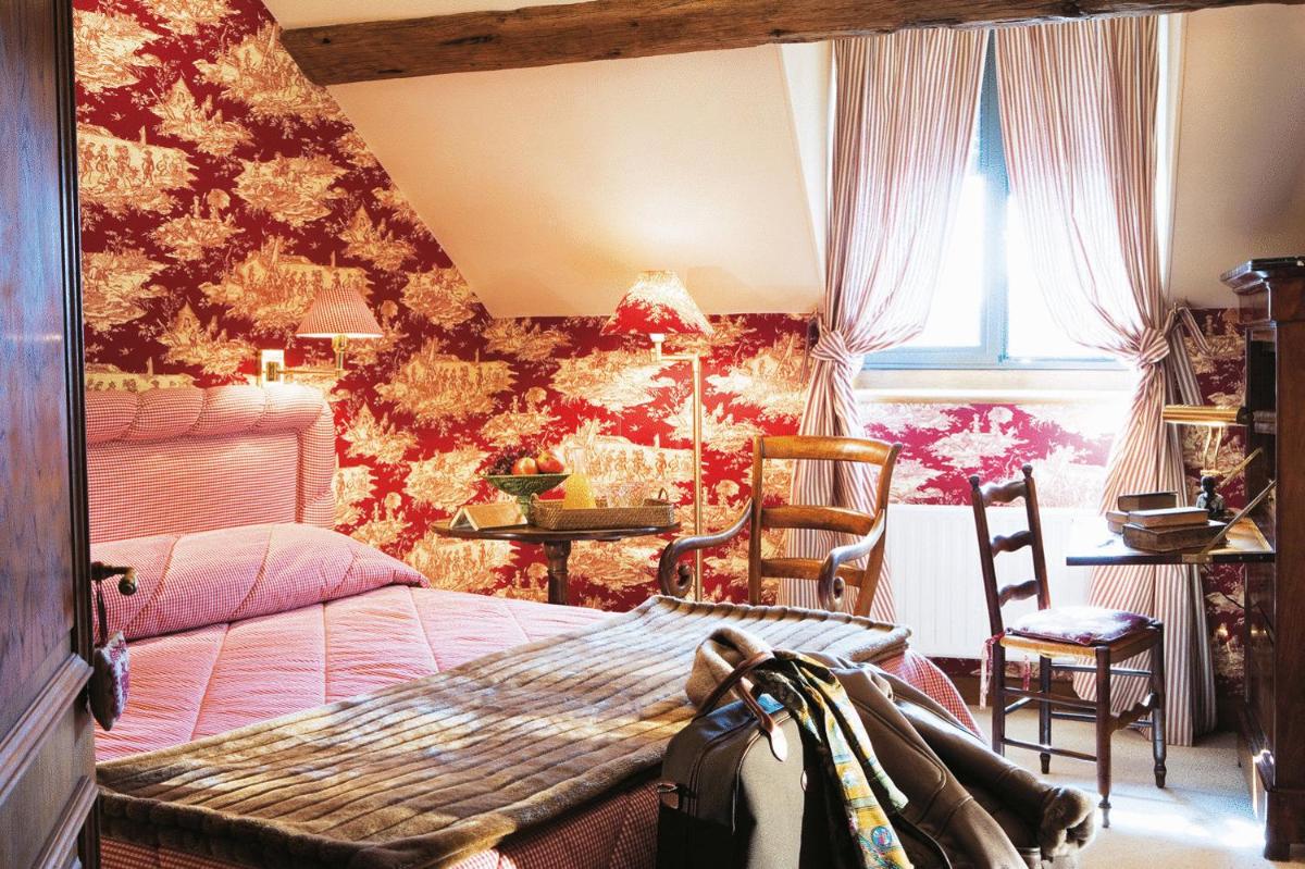 Un ou plusieurs lits dans un hébergement de l'établissement Hotel De France