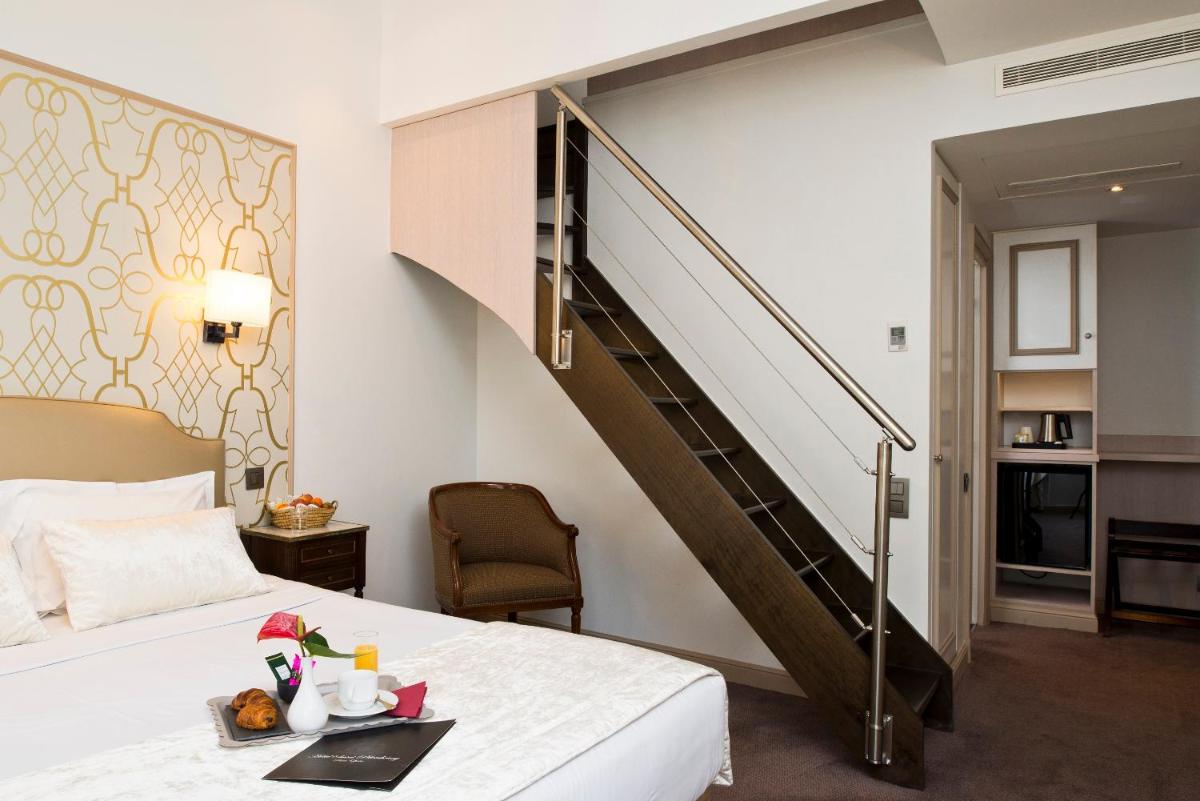 Un ou plusieurs lits dans un hébergement de l'établissement Hôtel Saint-Pétersbourg Opéra & Spa