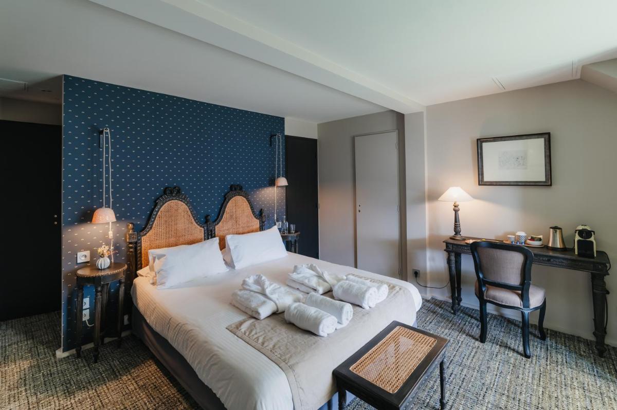Un ou plusieurs lits dans un hébergement de l'établissement Hôtel La Robéyère - BW Signature Collection
