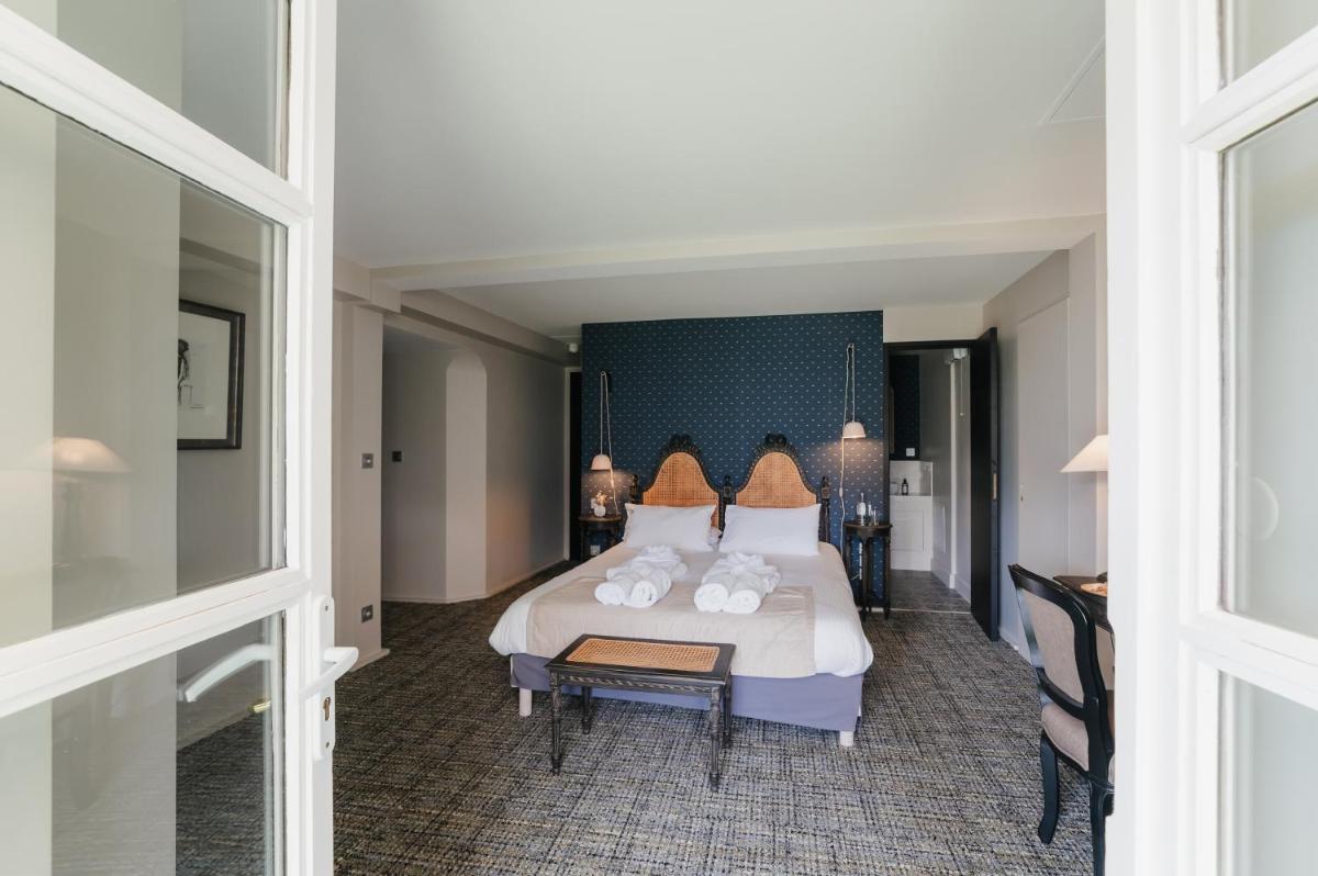 Un ou plusieurs lits dans un hébergement de l'établissement Hôtel La Robéyère - BW Signature Collection