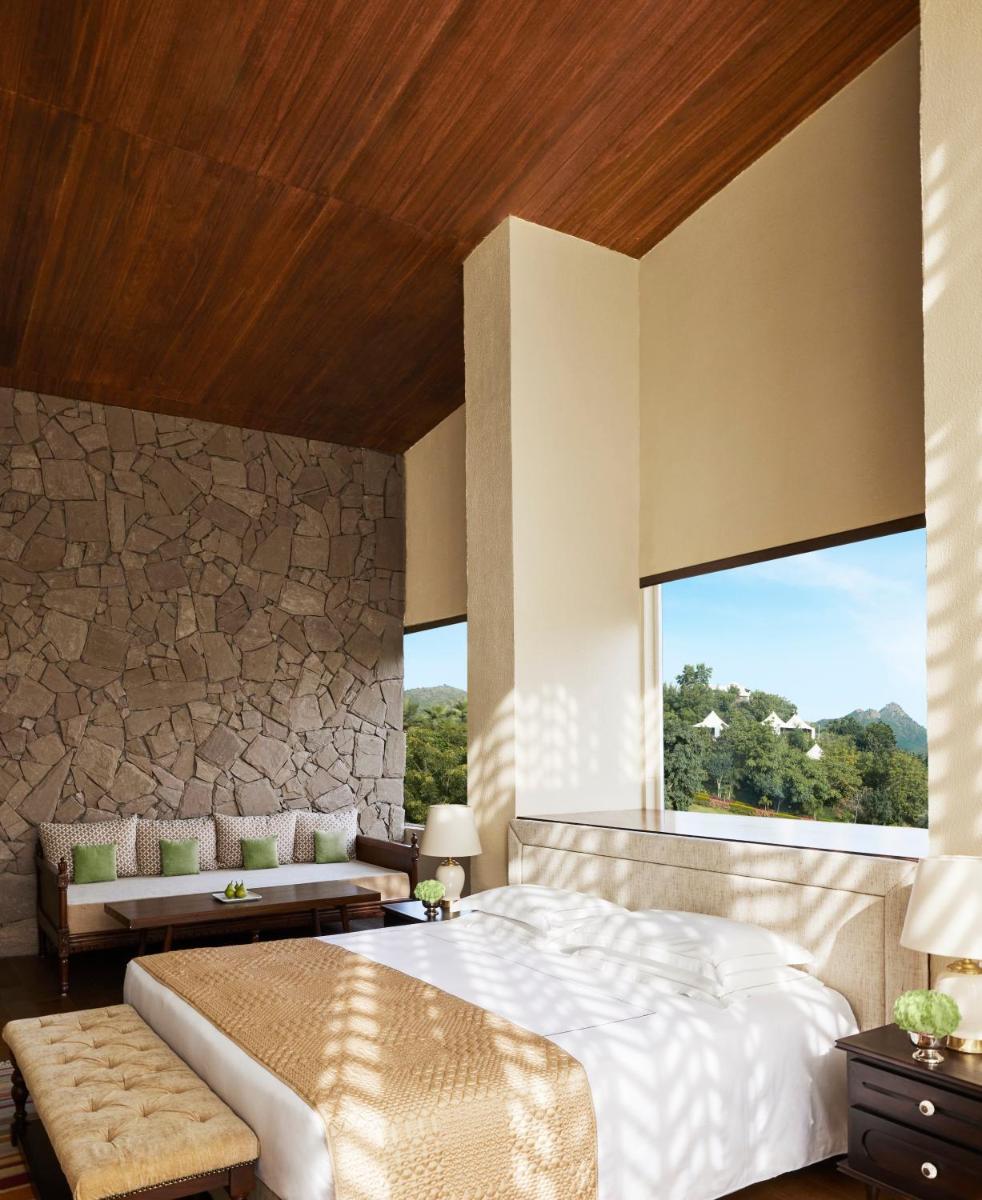 a bedroom with a large bed and a large window at Taj Aravali Resort & Spa Udaipur in Udaipur