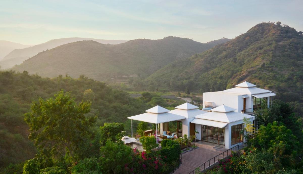 an aerial view of a house with mountains in the background at Taj Aravali Resort & Spa Udaipur in Udaipur