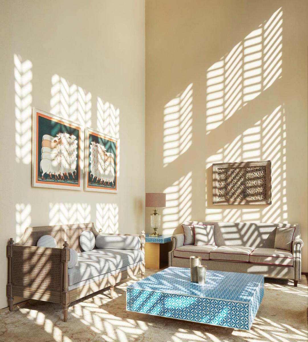 a living room with two couches and a table at Taj Aravali Resort & Spa Udaipur in Udaipur