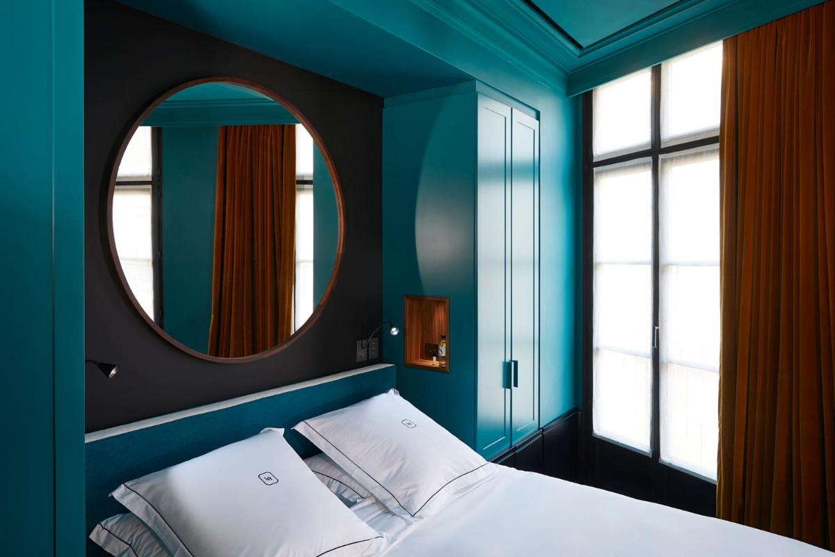 Un ou plusieurs lits dans un hébergement de l'établissement Le Roch Hotel & Spa