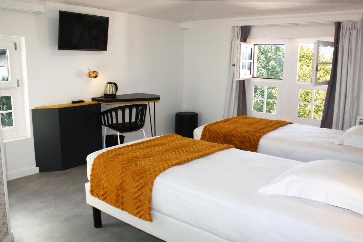 Un ou plusieurs lits dans un hébergement de l'établissement Hôtel du Parc & Spa
