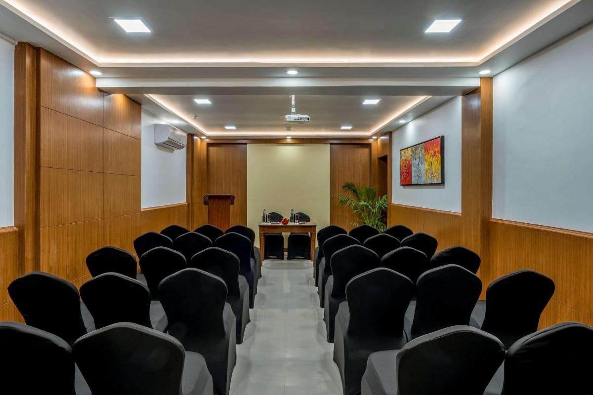 a conference room with black chairs and a table at Radisson Goa Candolim in Candolim
