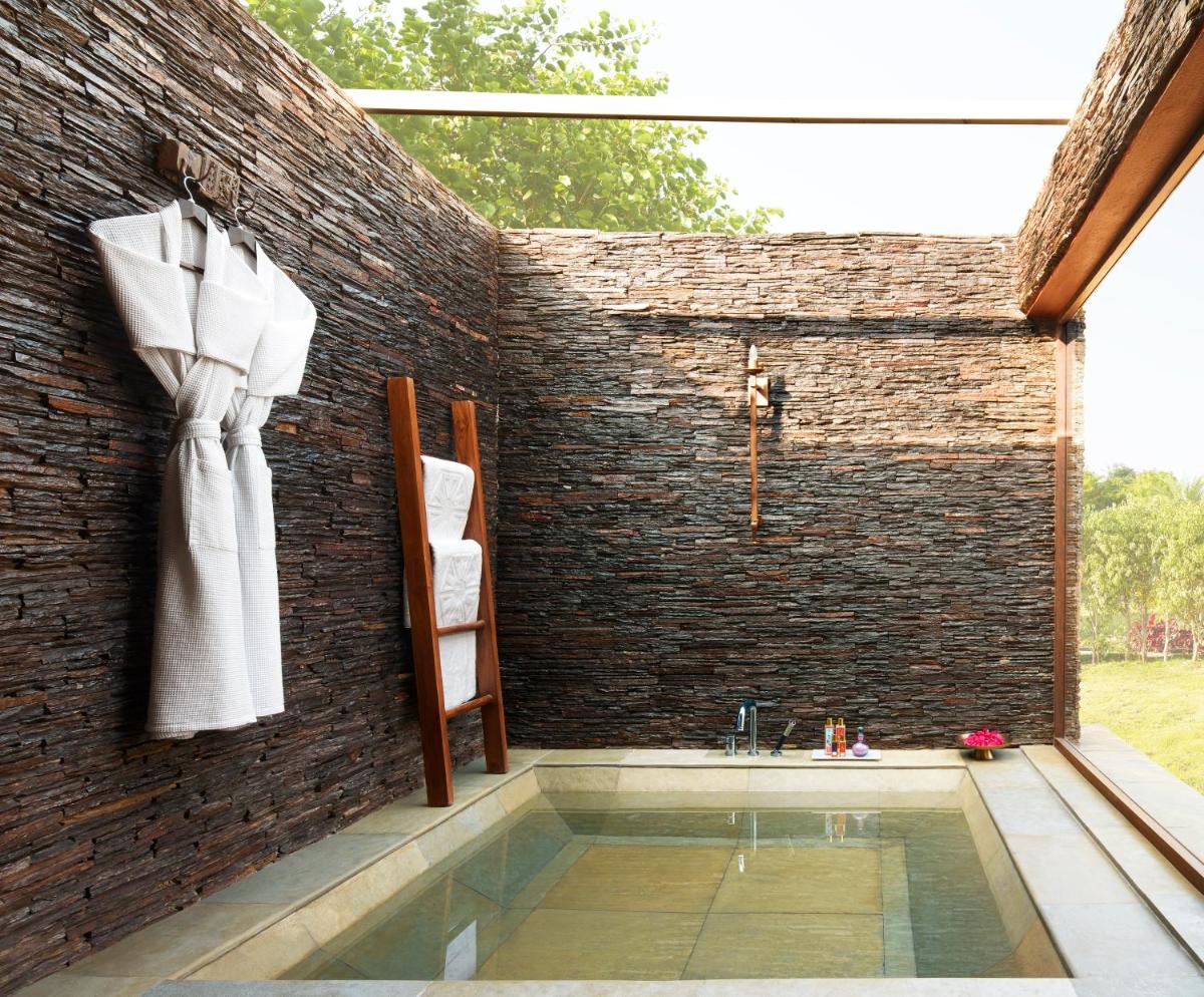 a bath tub with a sink in a brick wall at Taj Aravali Resort & Spa Udaipur in Udaipur