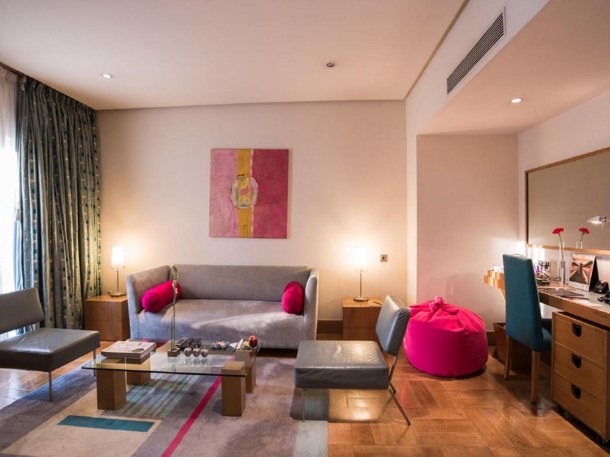 a living room with a couch and a table at The Park Bangalore, MG Road in Bengaluru a living room with a couch and a table at The Park Bangalore, MG Road in Bengaluru