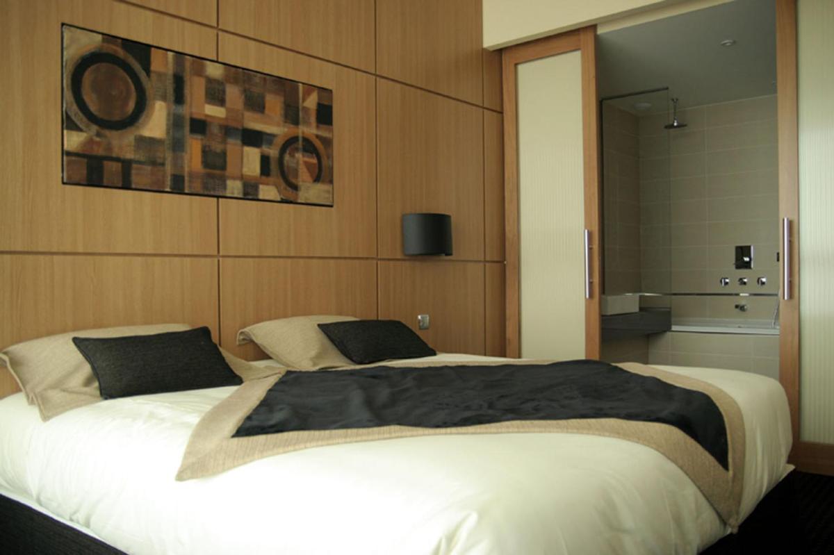 Un ou plusieurs lits dans un hébergement de l'établissement Hotel Spa Le Pasino