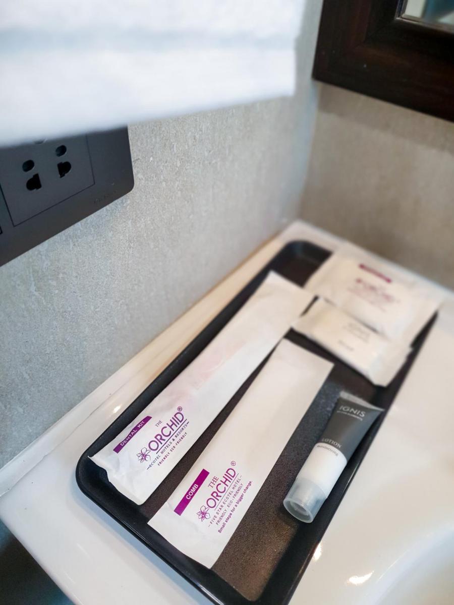 a counter top with two toothbrushes and a toothpaste at The Orchid Shimla in Shimla
