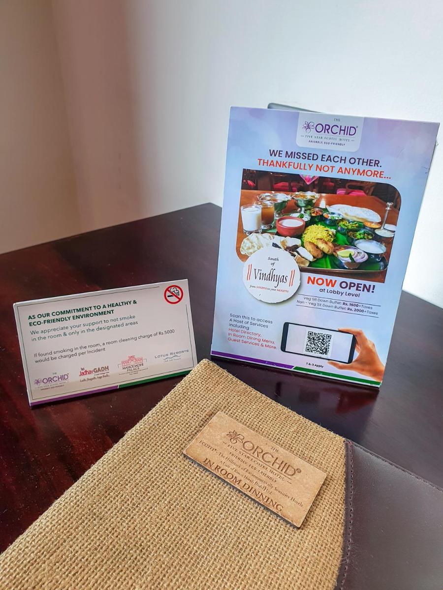 two boxes sitting on a table next to a book at The Orchid Shimla in Shimla