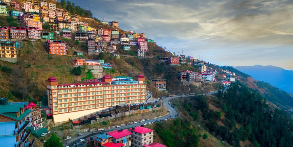 a group of buildings on the side of a mountain at The Orchid Shimla in Shimla