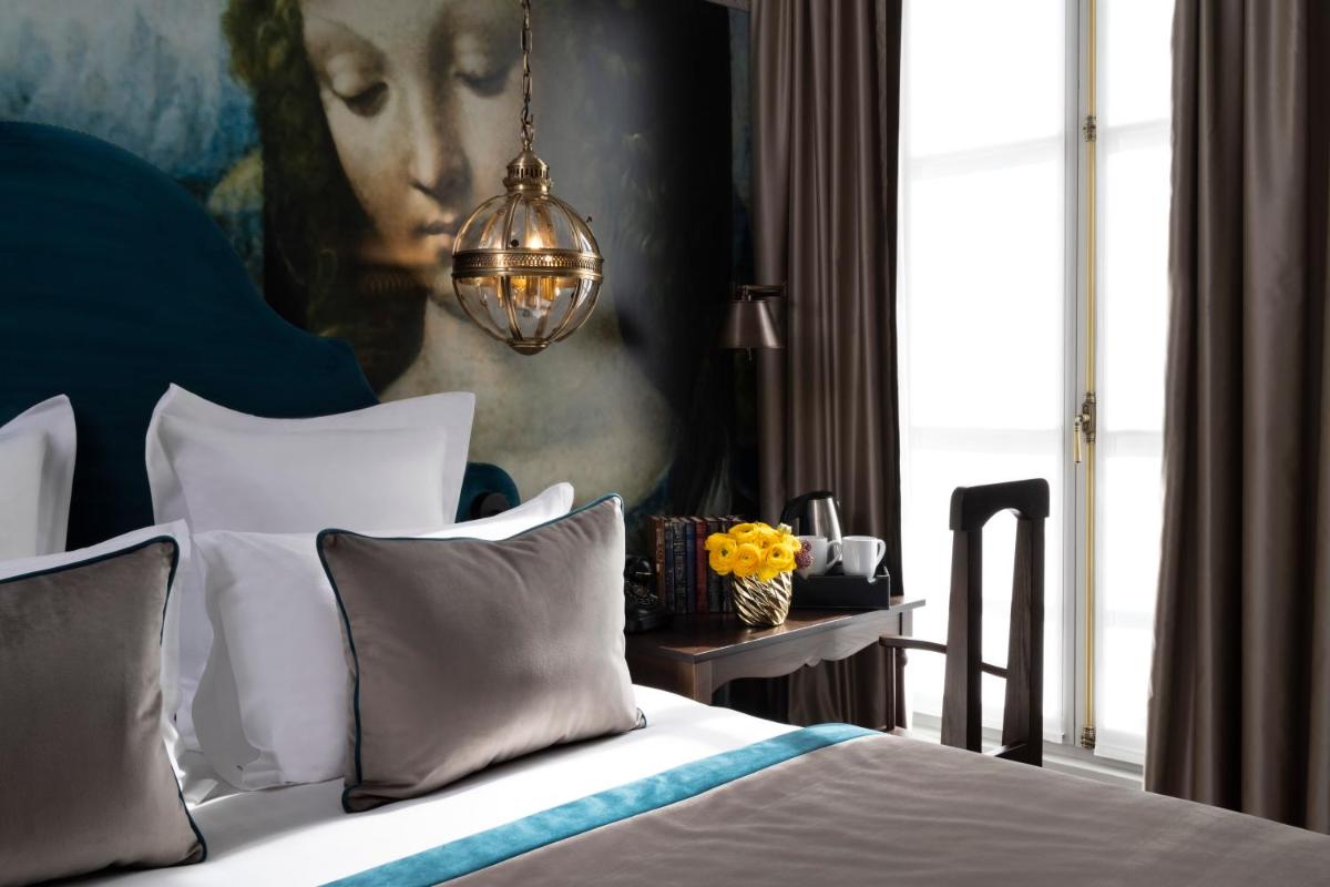 Un ou plusieurs lits dans un hébergement de l'établissement Hôtel & Spa Vinci Due