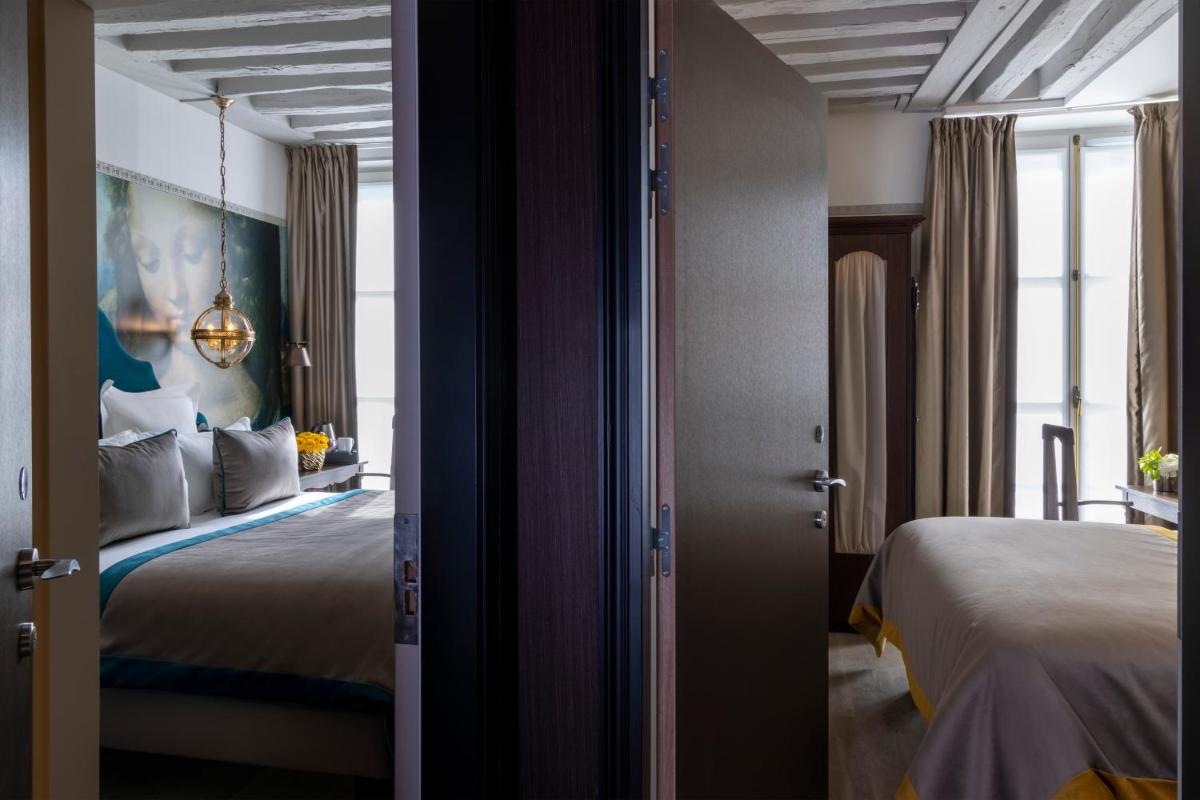 Un ou plusieurs lits dans un hébergement de l'établissement Hôtel & Spa Vinci Due
