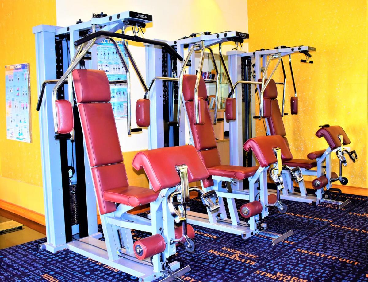 a row of tread machines in a gym at Hotel Royal Orchid Bangalore in Bengaluru