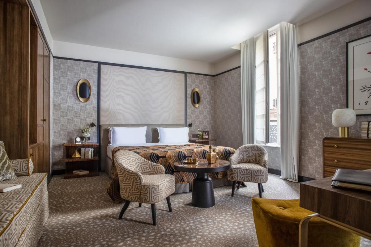 une chambre d'hôtel avec un lit, des chaises et une table dans l'établissement Esprit Saint Germain, à Paris